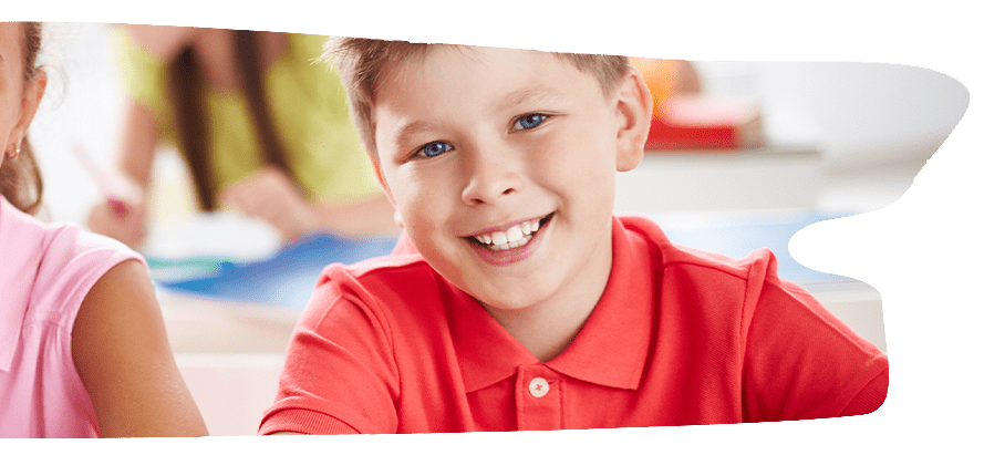 Smiling boy in a red polo shirt.