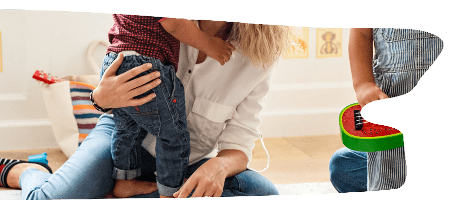 Parent and children playing on the floor.