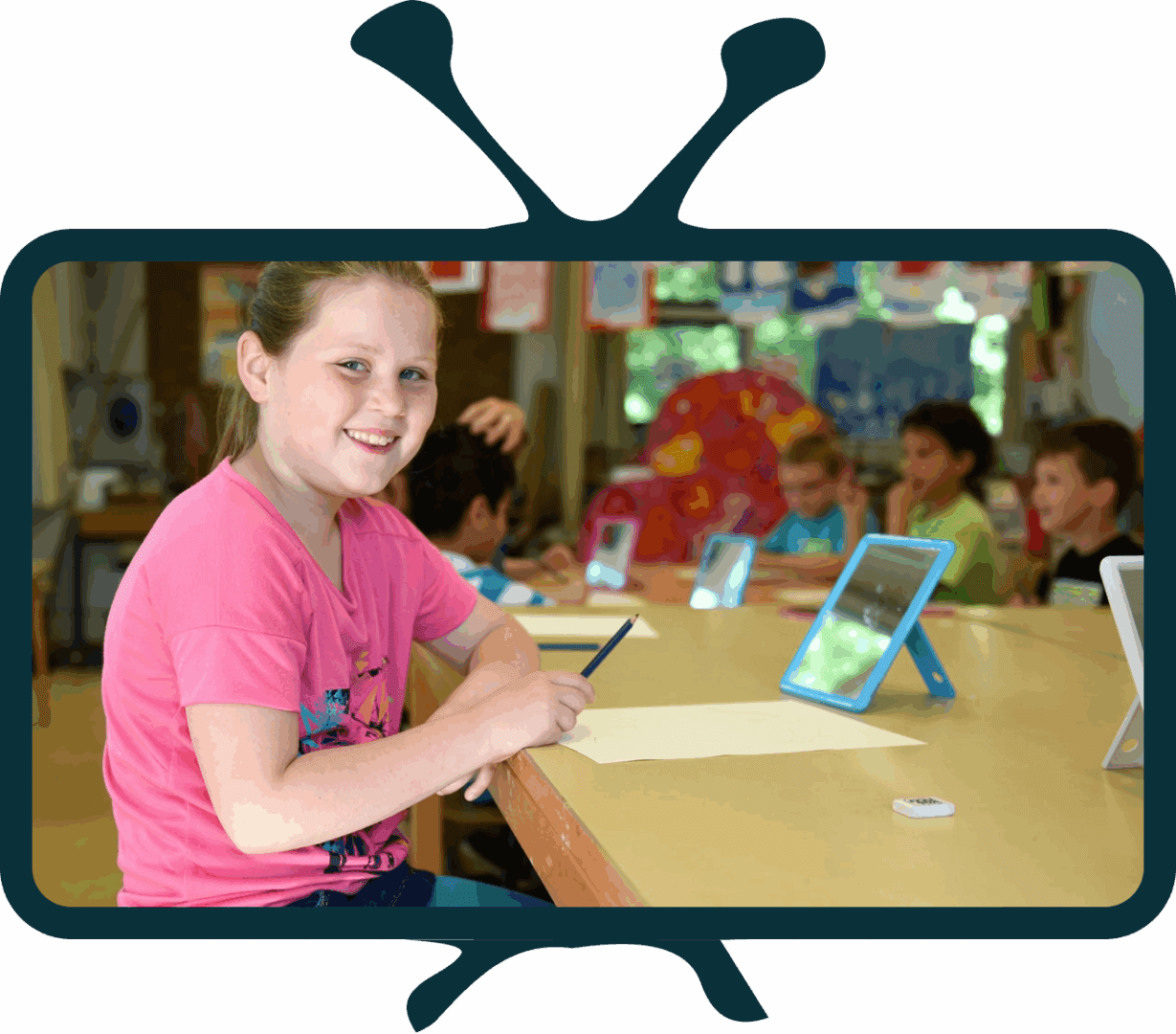 Child drawing with tablet in classroom.