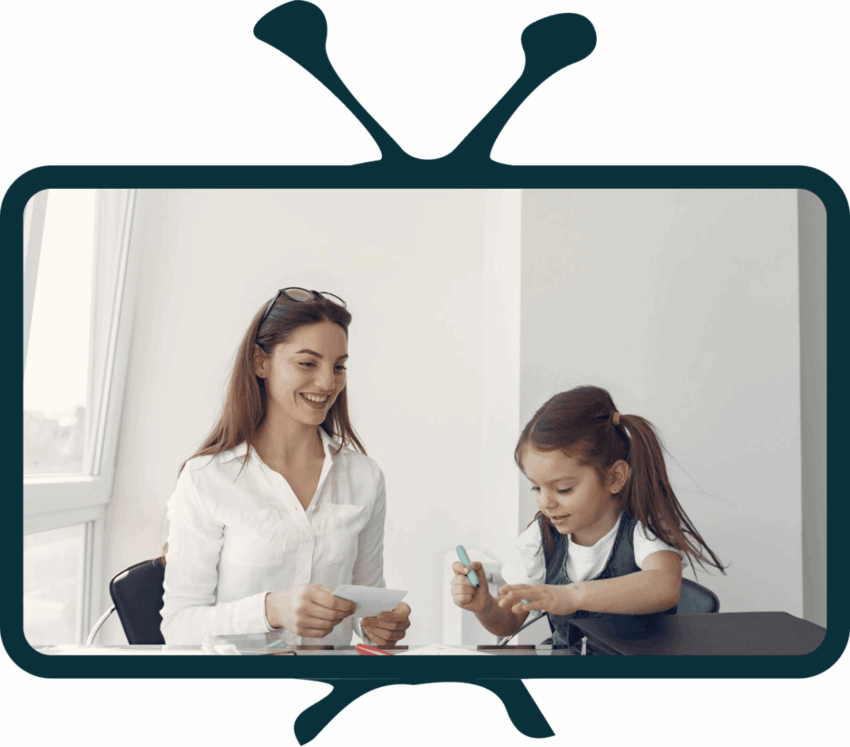 Adult and child interacting at a table.